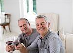 Portrait of senior men toasting wine glasses