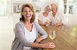Portrait of smiling senior women drinking white wine