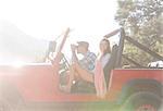 Couple sitting in sport utility vehicle