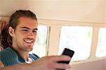 Man using cell phone in camper van