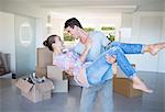 Man carrying girlfriend in new house