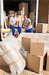 Movers sitting in moving van in driveway