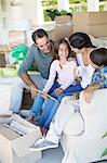 Family relaxing on sofa in new house