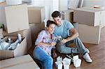 Couple enjoying champagne and Chinese take out food in new house