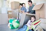 Family among cardboard boxes in livingroom