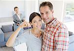 Portrait of smiling couple holding house keys