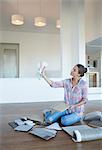 Woman viewing paint swatches in new house