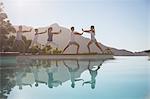 People practicing tai chi poolside