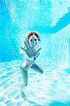 Portrait of smiling woman underwater in swimming pool