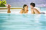 Couple relaxing in swimming pool