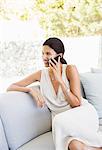 Woman talking on cell phone in livingroom