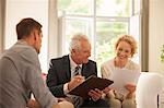 Financial advisor talking to couple in living room