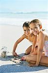 Girls playing in sand on beach