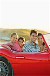 Family driving together in convertible