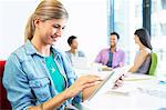 Businesswoman using digital tablet in meeting