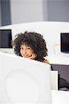 Businesswoman smiling at desk in office