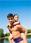 Portrait of Boy giving Girl Piggy Back Ride at Beach, Lampertheim, Hesse, Germany