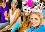 Friends wearing decorative glasses and crowns at party