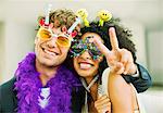 Couple wearing decorative glasses at party