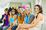 Friends wearing decorative glasses and headpieces at party