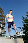 Boy with skateboard in a skatepark