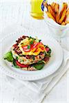 Turkey Burger on plate, sweet potatoe fries and beer, studio shot