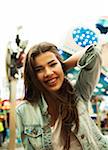 Close-up portrait of teenage girl at amusement park, looking at camera and smiling, Germany