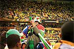 Soccer fans cheering inside a soccer stadium