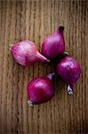 Red onions on wooden table