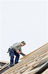 Man working on house roof