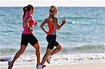 Young women running on beach, Algarve, Portugal