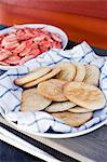 Flat bread and shrimps on plates, close-up