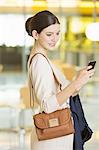 Businesswoman using cell phone in office