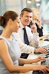 Businessman talking on cell phone in meeting