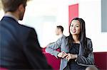 Business people talking in office lobby