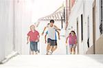 Children playing soccer in alley