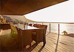 Dining table on luxury patio overlooking ocean