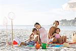 Family relaxing together on beach