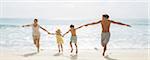 Family running together on beach