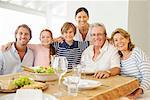 Multi-generation family smiling together at table