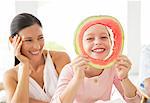 Mother and daughter playing with food