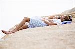 Couple relaxing on rock formation