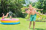 Father and daughter playing in backyard