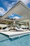 Patio and swimming pool along modern house