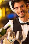 Close up portrait of well dressed bartender pouring wine