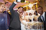 Groom pouring champagne pyramid at wedding reception