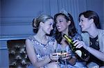 Well dressed women drinking champagne in luxury nightclub