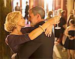 Close up of well dressed couple hugging in theater lobby