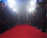 Paparazzi using flash photography along red carpet