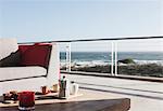 Breakfast on coffee table on modern patio overlooking ocean